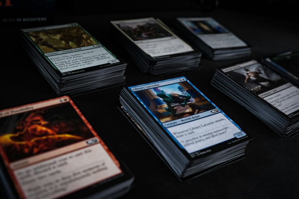A few piles of magic the gathering cards, reminiscent of a cube.